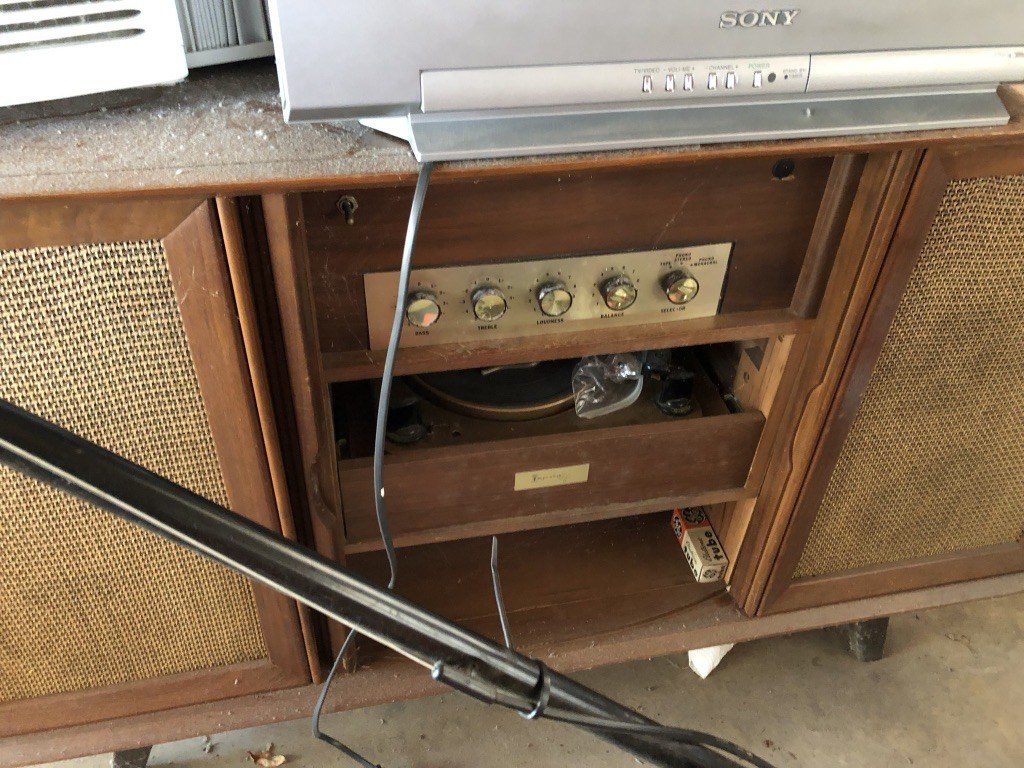 Original tuner knobs and turntable still in the unrestored cabinet